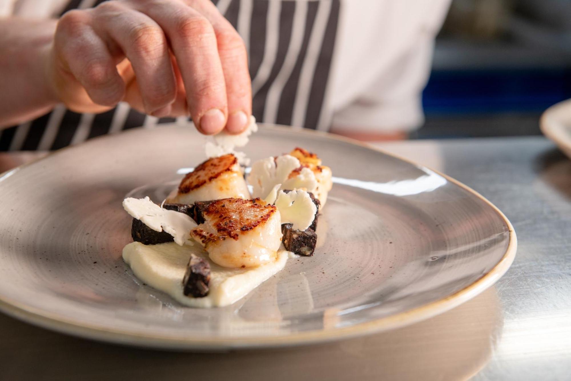 Отель The Millstone, Mellor Блэкберн Экстерьер фото A chef finishing a plate of scallops